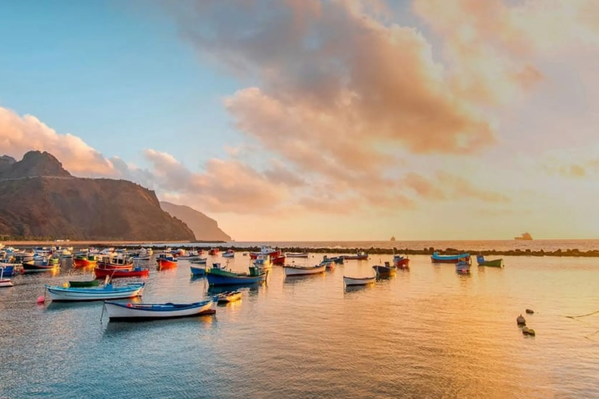 Beach with boats and sunset in the south of Tenerife